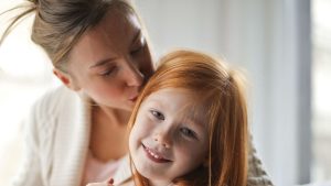 A mother Kissing Her Child