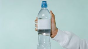 Person Holding Clear Plastic Bottle