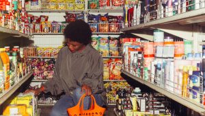 Woman Buying Groceries in a Convenience Store