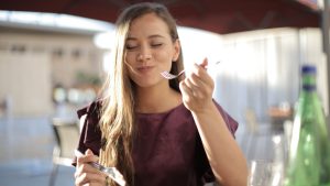 Woman in Purple Eating